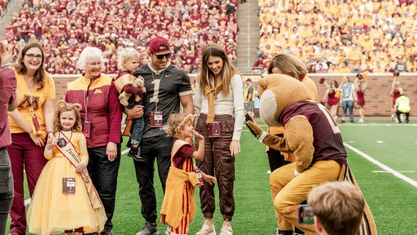 Goldy the Gopher mascot high-fiving Jr. Royalty