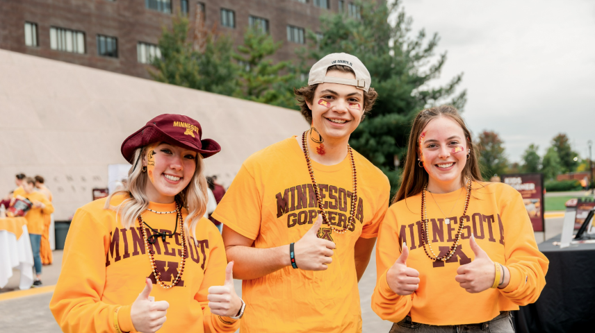 Students giving the thumbs up in their Minnesota gear at Ski-U-Mania